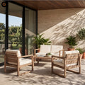 A 4-piece outdoor patio conversation set made of light brown wood with cream cushions, arranged on a covered patio with a matching coffee table.